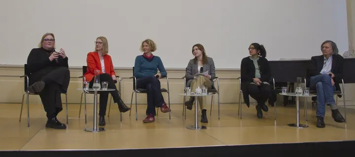 Panelists seated on a stage during the First Generation Academics podium discussion